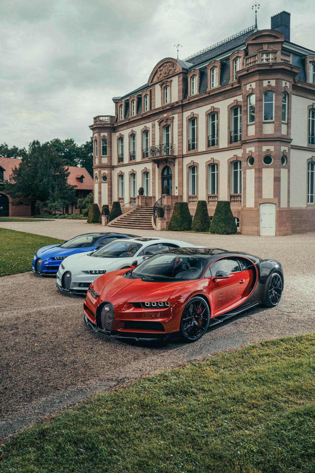 Bugatti celebrates France’s national day : three Chiron Sport in front of the Château Saint-Jean in Molsheim.