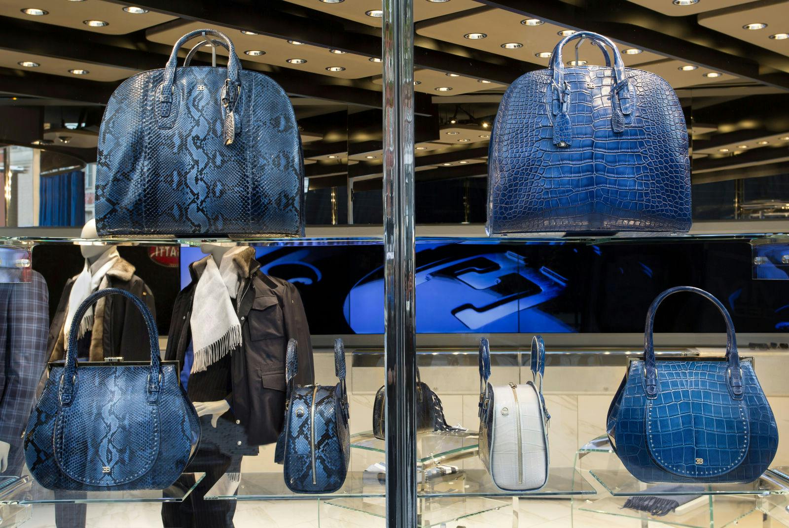 Inspired by the famous horseshoe grill shape of all of the Bugatti cars, the Bugatti signature bag is the star of the Bugatti boutique window displays.