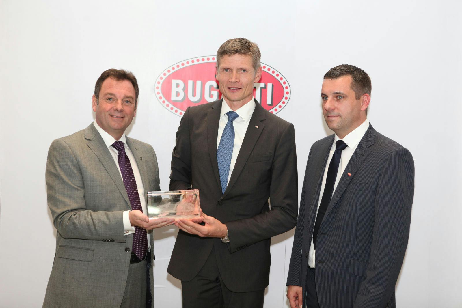 Joerg Maschwitz (centre), Director of Customer Service at Bugatti, presents the award “Service Partner of Excellence” to George Duncan, Director of Al Habtoor Motors – Bugatti Dubai. On the right: Sean Michael Jackson, After Sales Manager Al Habtoor Motors – Bugatti Dubai